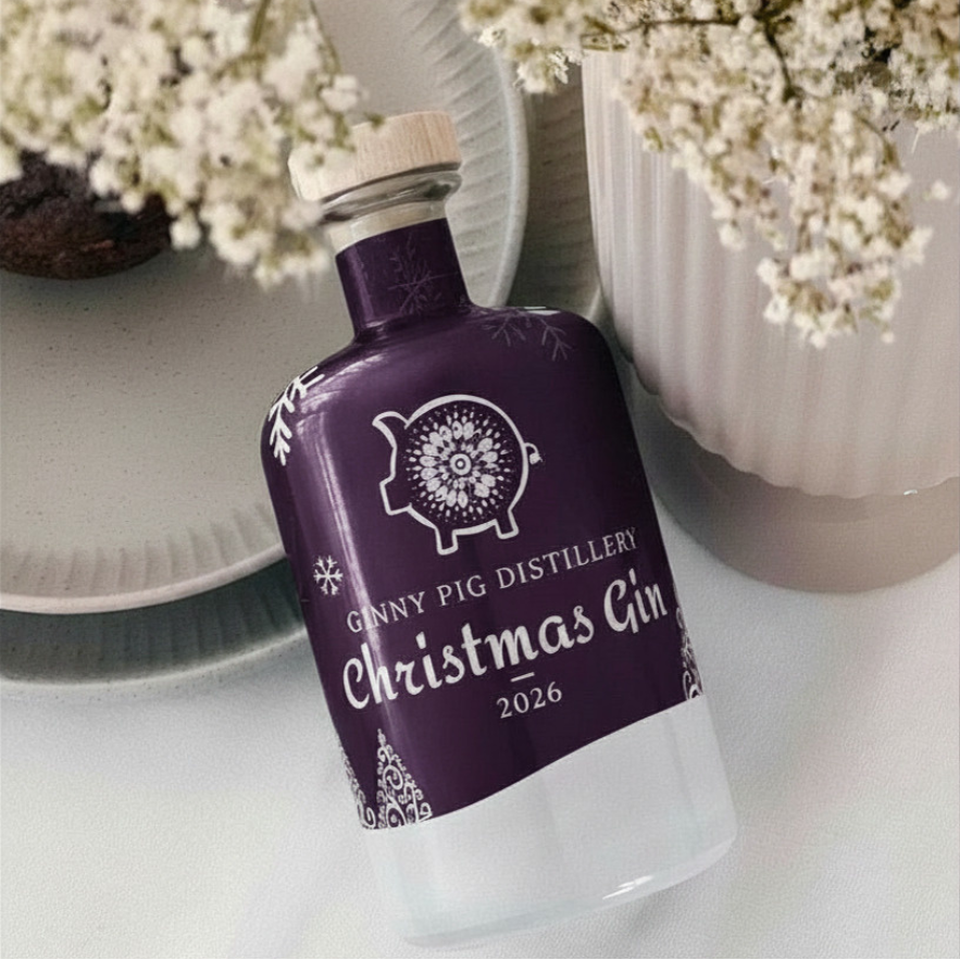Close-up of the purple Christmas Gin 2026 label with Ginny Pig logo, white snowflakes and Christmas tree designs.
