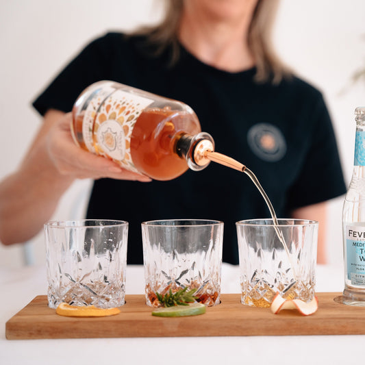 woman pouring Ginny Pig Spiced Fig Gin in to a glass